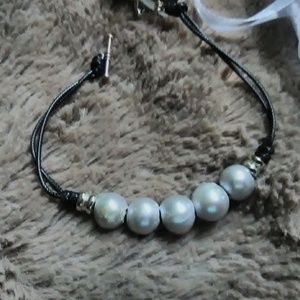 Bracelet, gray pearls and black cord.